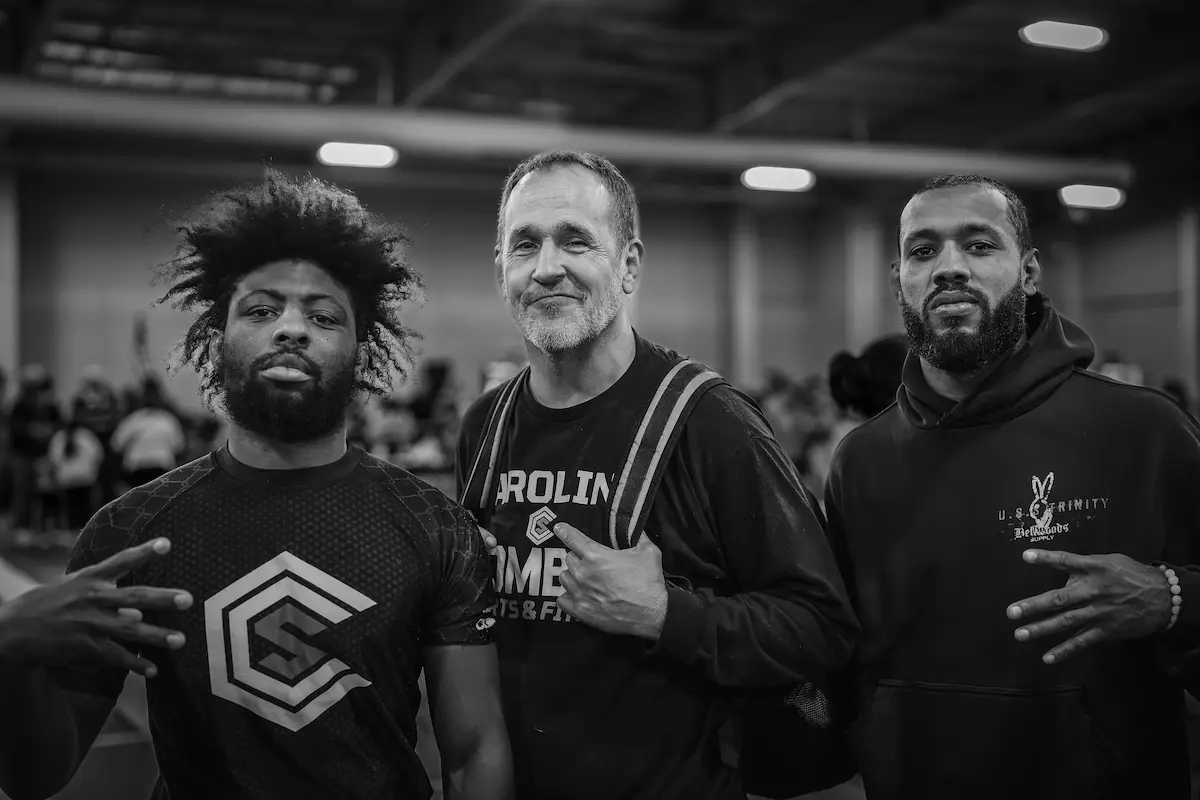 Tom Ziegler with two Carolina Combat Sports athletes at a competition.
