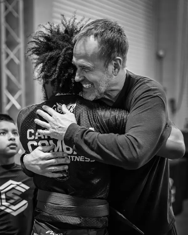 Tom Ziegler embracing one of his Carolina Combat Sports athletes after a match.